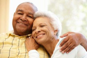 couple smiling after chrome guided dental implant surgery