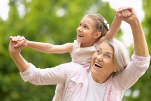 Dental Implant Patient Smiling With Her Grandchild