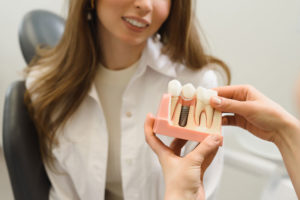 Dental Patient Getting Shown A Dental Implant Model During Her Consultation in Greensburg, PA