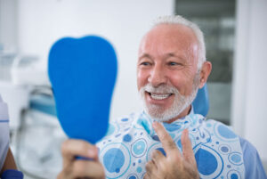an image of a man with dental implants.