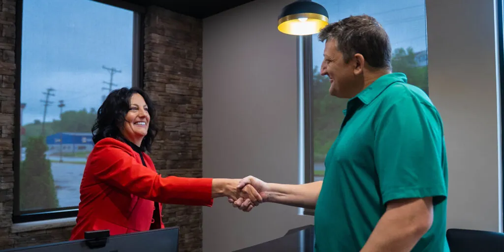 team member shaking Patients hand