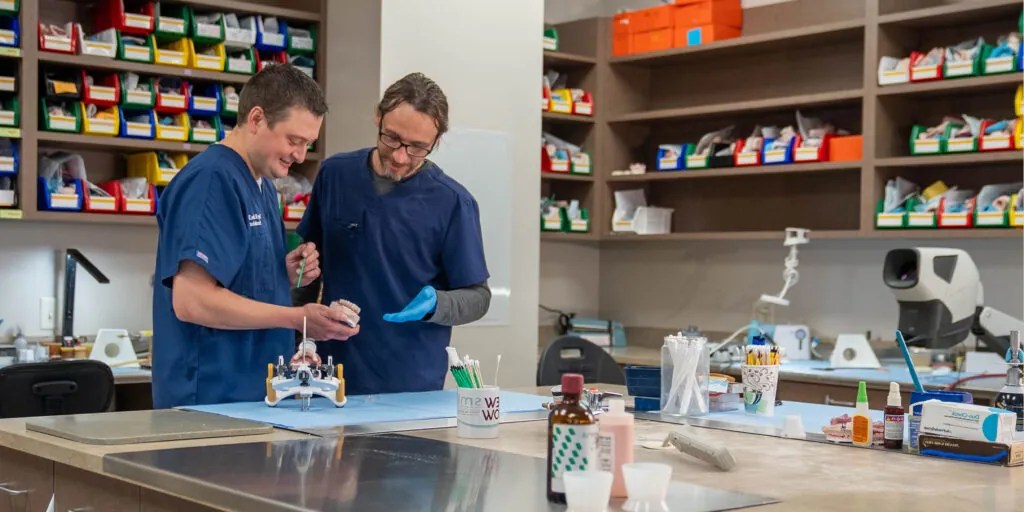 Team members working on a model dental implants