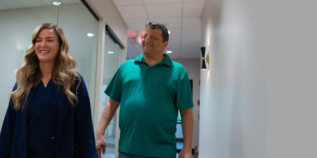 Patient walking with team member