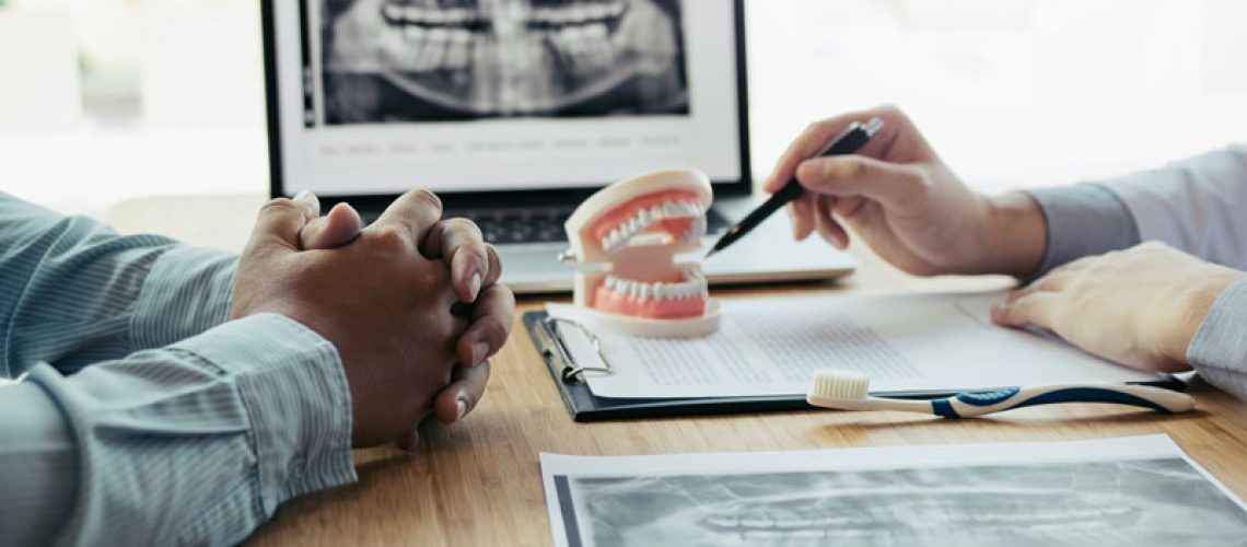 a dental implant dentist and a patient discuss dental implant surgery.