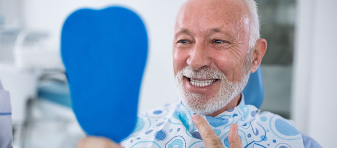 an image of a man with dental implants.