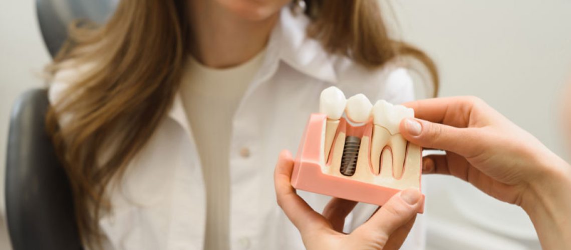 Dental Patient Getting Shown A Dental Implant Model During Her Consultation in Greensburg, PA