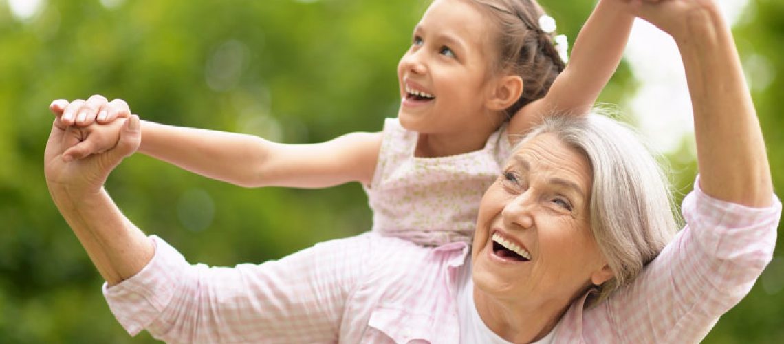 Dental Implant Patient Smiling With Her Grandchild
